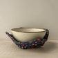 Ceramic bowl in a bowl cozy made with with fall decor fabric of leaves acorns squirrels on a blue backgroundc