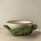 Ceramic bowl nestled in a Green football bowl cozy 
